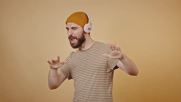 Mature Hipster Likes Listening to Music in Studio Closeup alt