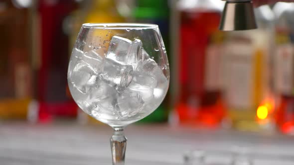 Jigger Pours Drink Into Glass alt