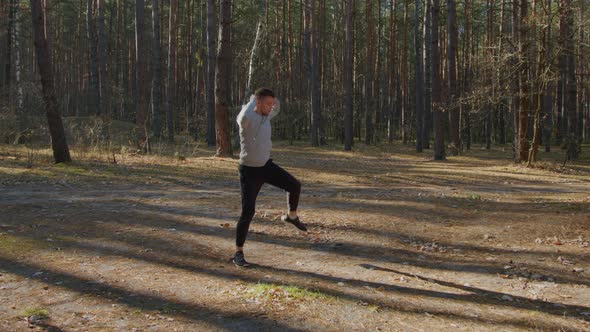 Athlete Is Warming Up In Forest Before Morning Run
