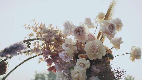 Close Up View of Wedding Floral Decorations Arch of Flowers in Pastel Faded Colors Slow Motion alt