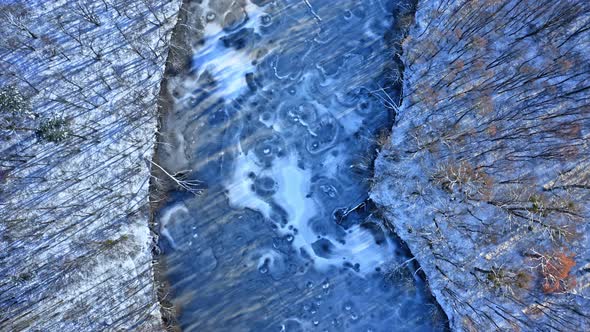 Winter cold river and forest. Aerial view of wildlife, Poland alt