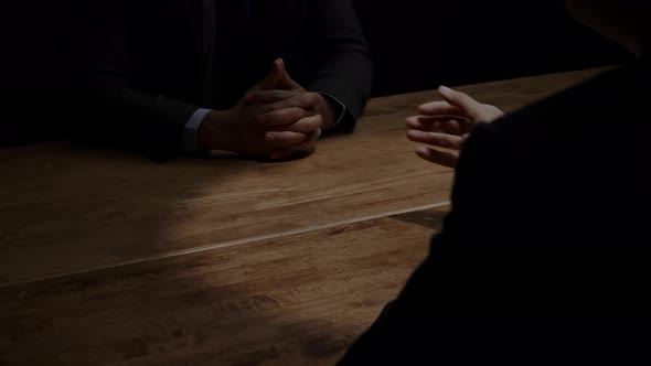 Businessman secretly giving money to his partner in the dark room