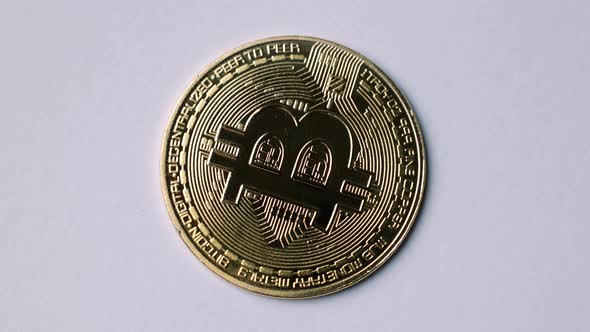 Bitcoin BTC coin rotate on 100 dollars USD bills. blockchain, mining GPU alt