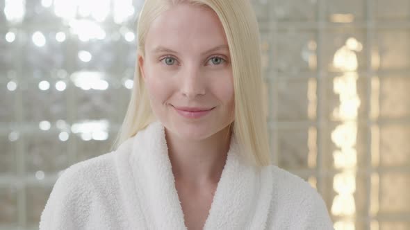 Portrait of Attractive Young Blond Woman Wearing Bathrobe With Natural Makeup Looking at Camera alt