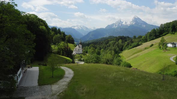 Aerial Fly Towards Church Maria Gern From Distance Mount Watzmann in Background Berchtesgaden alt