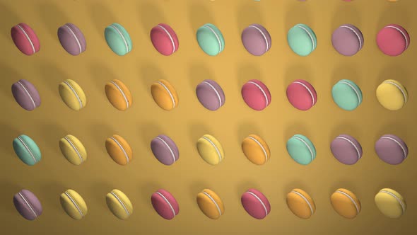 Multicolored macaron pastries photographed on light yellow paper background