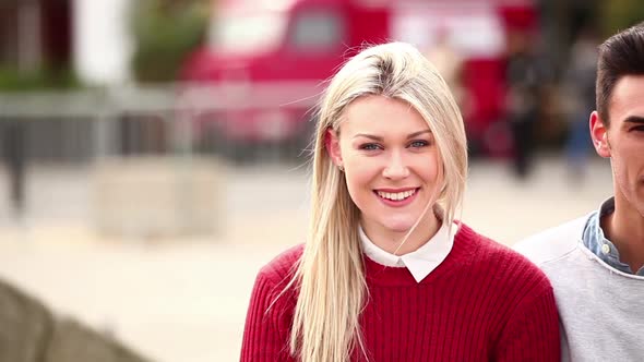 Group of friends seated on a bench, talking and laughing alt