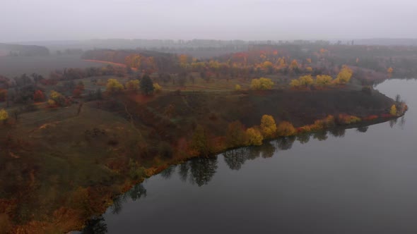 Aerial Drone Shot of Colorful Nature Near Big River in Fog at Late Autumn alt