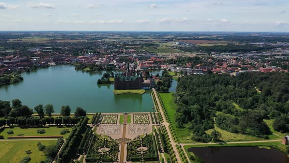 Aerial View Over An Opulent Garden And The Frederiksborg Castle In Hillerod Denmark - drone pullback alt