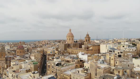 Domes of Basilica Of Senglea, in the Fortified Three Cities of Malta - Aerial slow Orbit shot alt