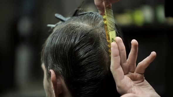 Haircut of Dark Haired Bearded Man in Barbershop