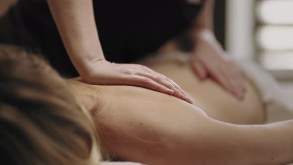 Manual Therapy for Health Spinal Professional Chiropractor is Massaging Female Body in Clinic alt