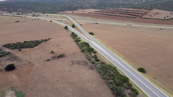 Aerial View of Vehicles Traveling Along Highway