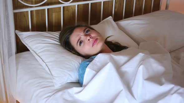 Uncomfortable Woman Sleeping in Bed at Night Restlessness alt
