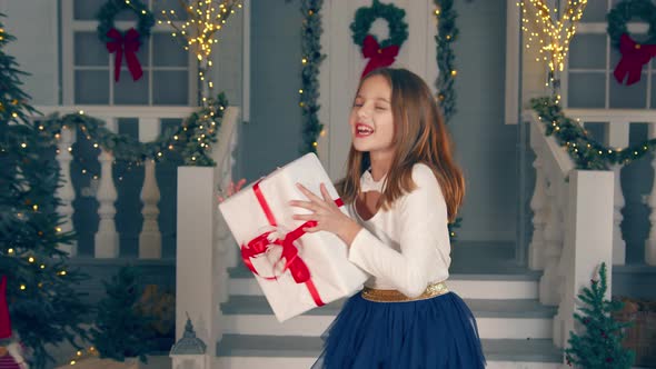 Little Girl Catches a Gift in a Big Box alt