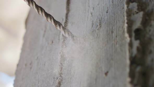 Man drilling hole in concrete wall. Repair works indoors in slow motion alt