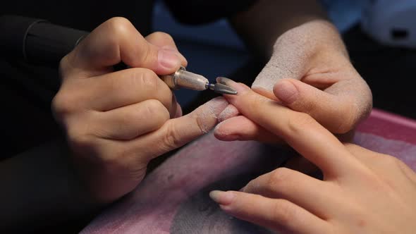 Anonymous Beautician Doing Manicure to Female Client