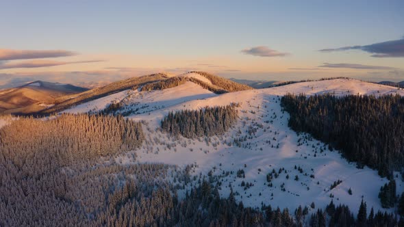 Winter Landscape at Sunrise. Beautiful Cinematic Footage. Aerial view of Snowy alt