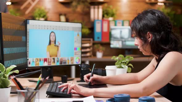 Female Photographer Uses a Professional Retouching Software or Application To Edit Photos alt