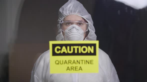 Woman in Protective Suit in Quarantine Zone. Coronovirus and Isolation Concept alt