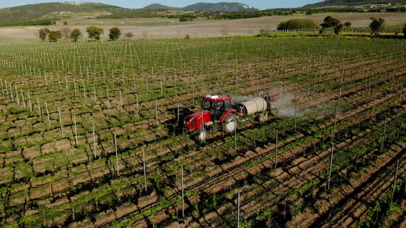 The tractor sprays fertilizes the fields with chemicals to protect crops from weeds and pests. alt