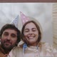 Happy Couple in Party Hats Unpacking Cardboard Box - VideoHive Item for Sale