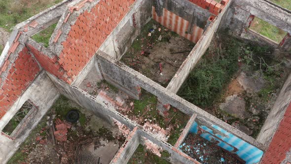 Abandoned and dilapidated roofless house after the war. Only walls are left of what once was a home. alt