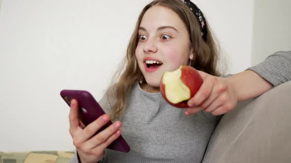 Amazed Kid Surprised with News in Phone Eat Apple Emotions alt