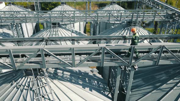 Engineer Servicing and Inspecting Large Grain Storage Containers alt