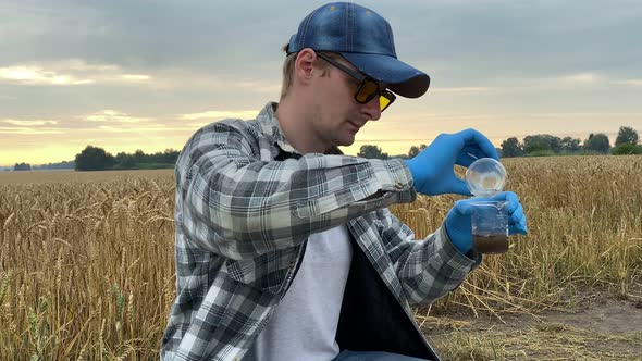 Agronomy Scientist Conducting Soil Analysis Outdoors alt