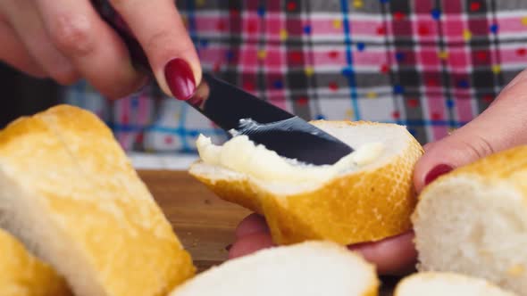Female Hands Smear Butter on Bread alt