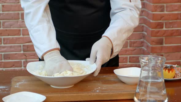 Making Dough By Male Hands on Wooden Table alt