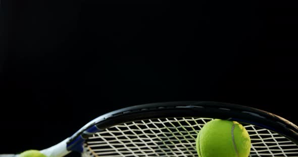 Close-up racket arranged on tennis balls alt