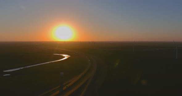 Wind Energy Blows Into West Texas Wind Turbine Farms in the Colorful Sunset Showing Renewable Energy alt