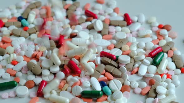 Close-up with different colorful pills and drugs. Pills poured on the table.