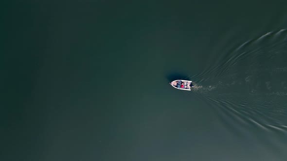 Aerial Top View of Motor Boat with Tourists Sails on the River alt