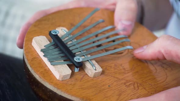 Mbira thumb piano played by young white man alt