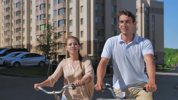 Happy Couple on Bicycles Stop Chat Smile