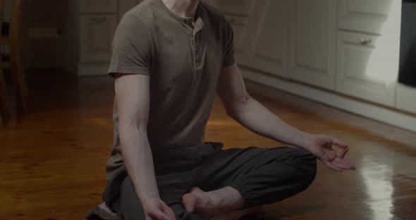 Tranquil Man Meditating in Lotus Pose Alone at Home Background Slow Motion