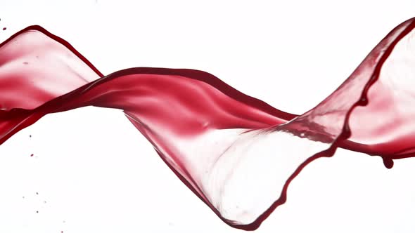 Super Slow Motion Shot of Red Wine Spiral Splash Isolated on White Background at 1000Fps alt