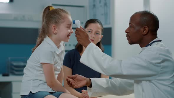 physician-using-thermometer-on-kid-to-measure-temperature-stock-footage