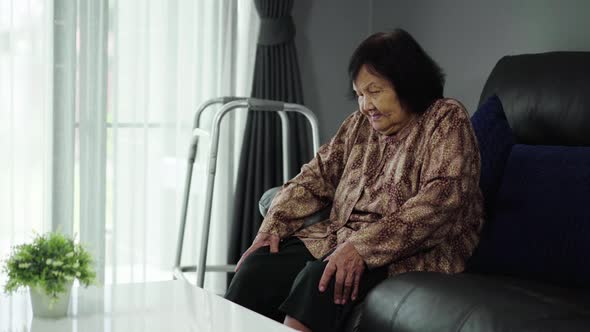 Senior woman suffering from pain in knees at home