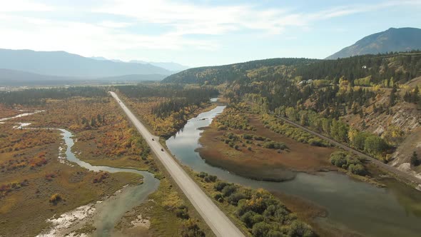 Aerial View of a Scenic Highway Around Mountains alt