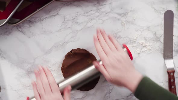 Flat lay. Step by step. Cutting out shapes with Christmas cookies cutter from gingerbread cookie dou alt