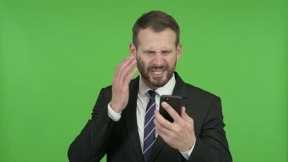 Frustrated Young Businessman Get Angry on Call Against Chroma Key alt
