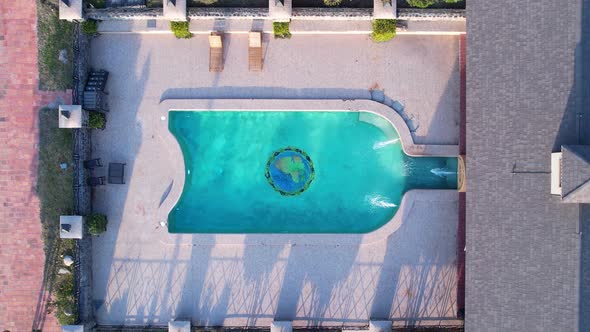Top down view of swimming pool in bottle of wine format. alt
