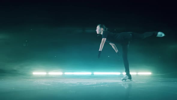 Ice Rink with a Young Female Skater Spinning Gracefully alt