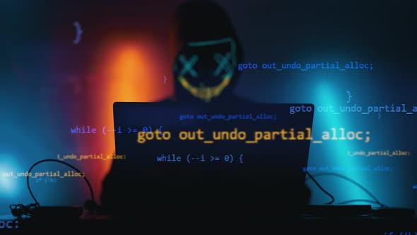 Hacker is Working on Laptop at Night alt