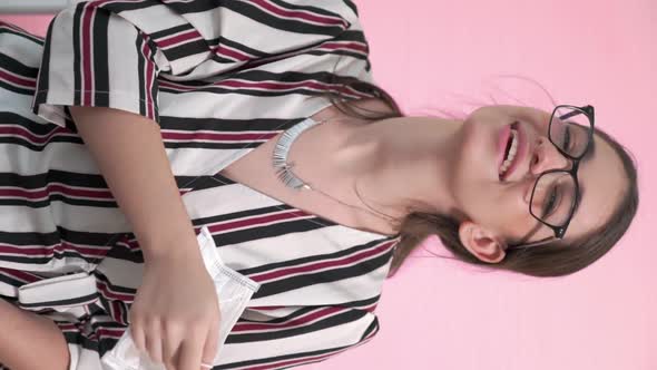 Vertical Video of Young Woman Take Off Face Mask Removing From Face alt