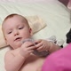 The masseuse gives a tummy massage to baby (boy) 20 - VideoHive Item for Sale